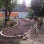 The start of the project, removing the top turf and raising the area to be paved over the tree roots
