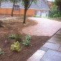 The finished product, a raised patio area using paving bricks and a shrubbed area created
