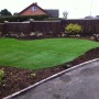 A final shot of the newly layed artificial grass complimented with willow screening in the newly landscaped garden